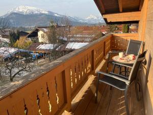 a table with a plate of food on a balcony at Chalet Bergromantik in Reit im Winkl