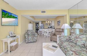 a living room with a couch and a dining room at Serenity By The Sea I Crescent Sands I Windy Hill I North Myrtle Beach in Myrtle Beach