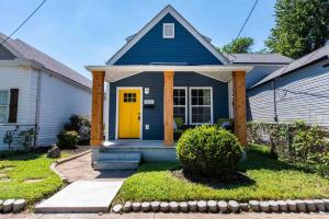 a blue house with a yellow door at Newly Renovated 3 Bedroom Shelby Park Home **FREE PARKING** in Louisville