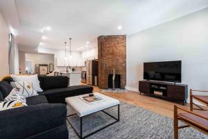 a living room with a couch and a fireplace at Newly Renovated 3 Bedroom Shelby Park Home **FREE PARKING** in Louisville