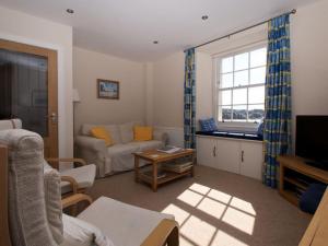 a living room with a couch and a table at Quayside Cottage in North Berwick