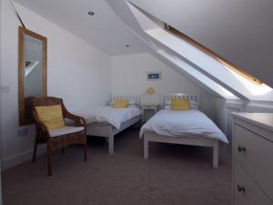 a attic room with two beds and a mirror at Quayside Cottage in North Berwick