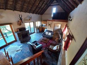 an aerial view of a living room with a fireplace at Fijnbosch Self Catering Chalet in Jeffreys Bay