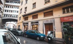 a blue car parked in front of a building at Acacia Firenze - Avocado in Florence