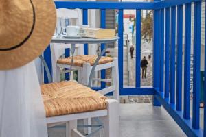 a blue and white porch with a table and chairs at Aelia Suite I / Mykonos Town in Mýkonos City