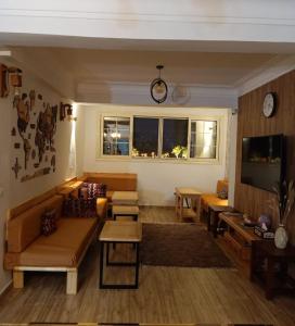 a living room with a couch and a table at Champollion Hostel in Cairo