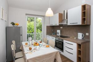 a kitchen with a table with food on it at Apartments Villa Mirjana in Mlini