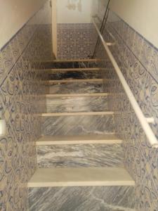 a set of stairs in a room with tiles at Casa da Romeira in Elvas