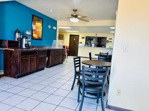 a kitchen and dining room with a table and chairs at Rodeway Inn Winslow I-40 in Winslow