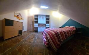 a bedroom with a bed and a dresser and shelves at Le Thiers Appartement in Auxonne