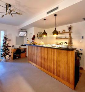 a kitchen with a bar with a christmas tree behind it at Incanto B&B Cefalù in Cefalù