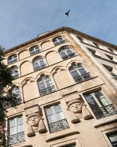 a building with faces on the side of it at Hôtel du Sentier in Paris