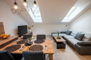 a living room with a couch and a table at Lázeňské Apartmány in Náchod