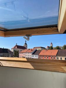 a window with a view of buildings in the background at Penzion Brtnice in Brtnice
