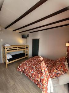 a bedroom with a bed and a bunk bed at Hotel Aragon in Perpignan