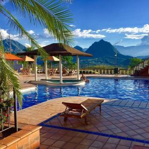 a pool with a table and a bench next to it at Real Dinastía in La Pintada