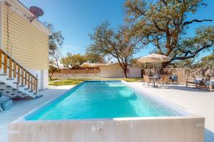 a swimming pool in the backyard of a house at The Mathis House in Rockport