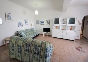 a living room with a couch and a tv at Casa MARINELLA in Lipari