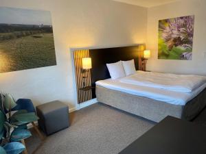 A bed or beds in a room at Hotel Dalgas, BW Signature Collection