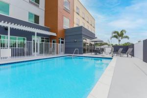 a swimming pool in front of a building at Fairfield by Marriott Inn & Suites Cape Coral North Fort Myers in Cape Coral