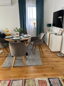 a living room with a table and chairs at B-Apartment Vienna 12 in Vienna
