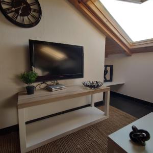 a living room with a flat screen tv on a wall at Apartments Obala in Malinska