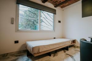 a bed in a room with a window at Departamentos M65 Luxury in Córdoba