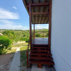 a wooden staircase leading up to a house with a view at Casa Bouganville in Monte das Gameleiras