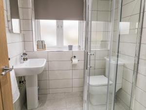 a bathroom with a shower and a sink and a toilet at Moor View in Skipton