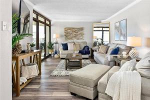 a living room with a couch and a table at Ocean Front Sea Terrace 209 Heated Pool in Ocean City