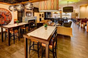 a restaurant with tables and chairs and a bar at Delta Hotels by Marriott Saint John in Saint John