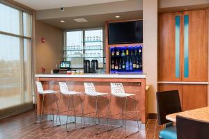 a bar with white bar stools in a restaurant at SpringHill Suites by Marriott Chicago Southeast/Munster, IN in Munster