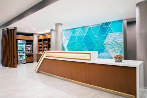 a lobby of a pharmacy with a large mural on the wall at SpringHill Suites by Marriott Miami Doral in Miami