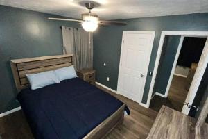 a bedroom with a bed and a ceiling fan at Quiet Getaway in La Follette