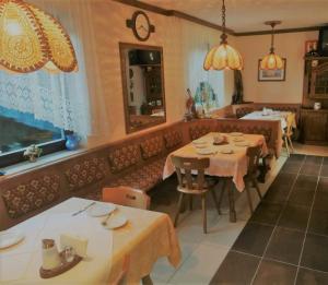 a dining room with two tables and a couch at Pension Katharina Frühstück ab 5 Uhr früh in Seeboden