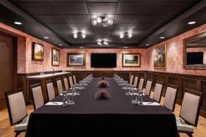 a conference room with a long table with wine glasses at Hotel LeVeque, Autograph Collection in Columbus