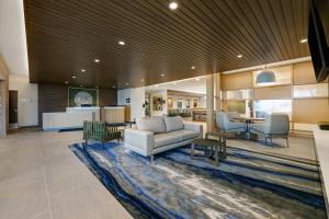 a living room with a couch and chairs on a rug at Fairfield by Marriott Inn & Suites Denver Airport at Gateway Park in Denver