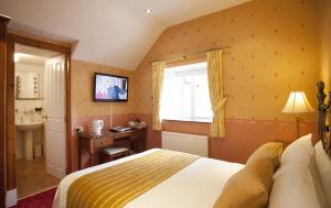 a bedroom with a bed and a sink and a window at Roseneath Guest House in Inverness