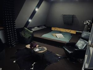 a room with a bed and a couch and a chair at 2 Rooms Oelde B in Oelde
