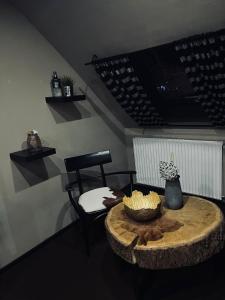 a room with a table and a chair with a bowl of food at Oelde Apartment in Oelde