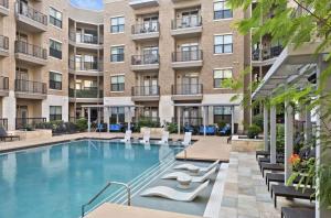 an image of a swimming pool in front of a building at NEW! Modern & Spacious 1Br/1Bth in Central ATX! Close To Austin Hotspots! in Austin