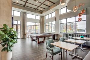 a restaurant with tables and chairs and windows at Glamour Homes with balcony view, free champagne, parking next to major attractions in Bloomington