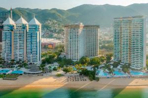 an aerial view of a beach and buildings at Dreams Acapulco in Acapulco