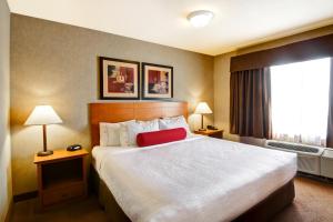 Voodi või voodid majutusasutuse Ramada by Wyndham Ponoka toas