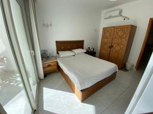 a bedroom with a bed and a glass door at Blue Vision Diving Hotel in Marsa Alam City