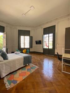 a large room with a bed and a rug at Casa Marina Huérfanos in Santiago