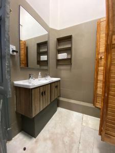 a bathroom with a sink and a mirror at Casa Marina Huérfanos in Santiago