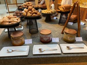 a table of food with spoons and other foods at The St. Regis Punta Mita Resort in Punta Mita