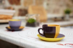two cups and saucers sitting on a counter at Dragazzo studio in Trogir