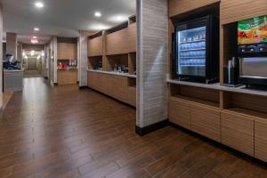 a lobby with a large television and wooden cabinets at TownePlace by Marriott Suites Gallup in Gallup